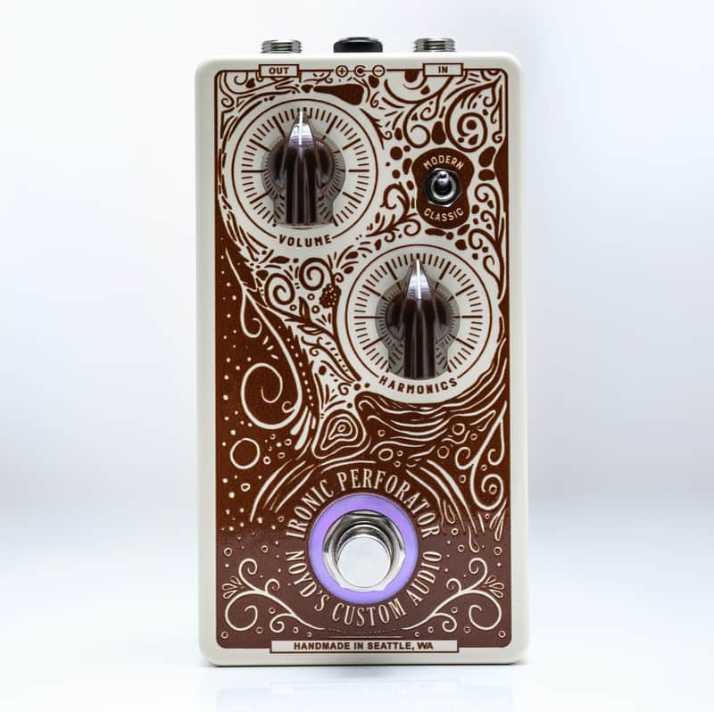 The Ironic Perforator: cream enclosure with ornate brown filigree print, Volume and Harmonics knobs, Classic/Modern toggle